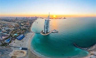 The Burj Al Arab and Dubai coastline at sunrise, a potential MSC Cruises destination | MSC Cruises The Burj Al Arab and Dubai coastline at sunrise, a potential MSC Cruises destination | MSC Cruises