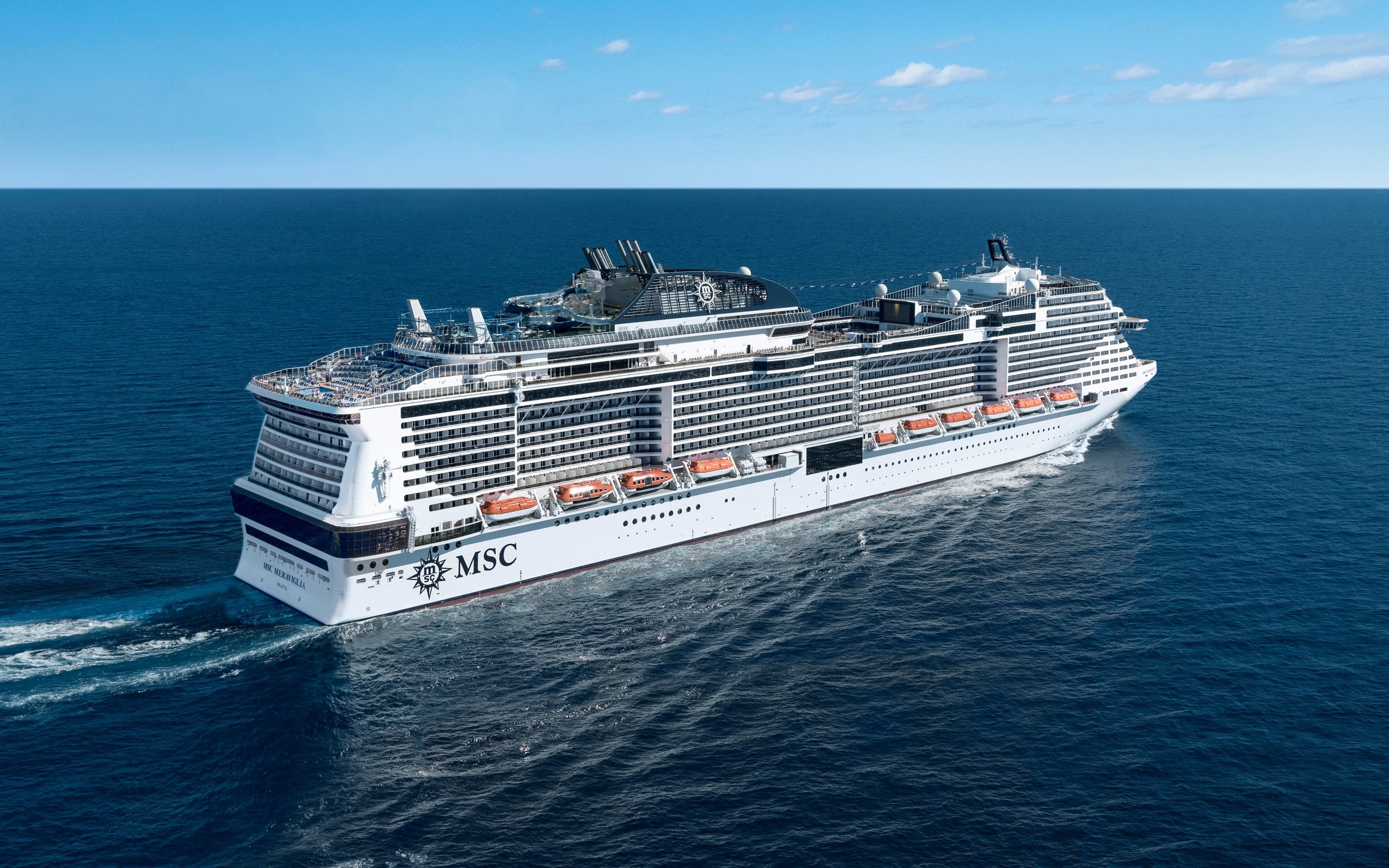 An MSC cruise ship sailing on the open sea under a clear blue sky | MSC Cruises An MSC cruise ship sailing on the open sea under a clear blue sky | MSC Cruises