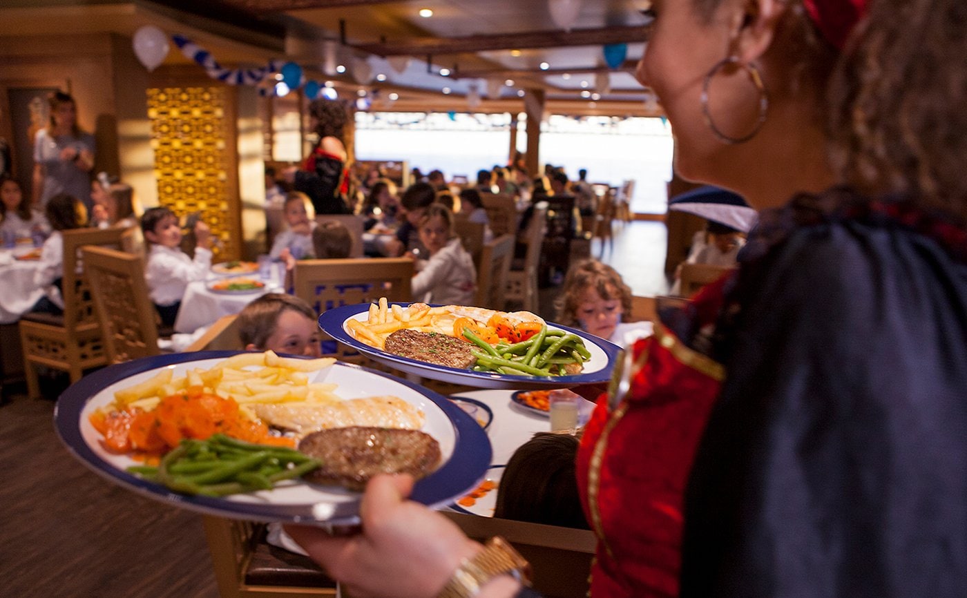 A vibrant dining area on a cruise ship with plates of gourmet food being served | MSC Cruises A vibrant dining area on a cruise ship with plates of gourmet food being served | MSC Cruises