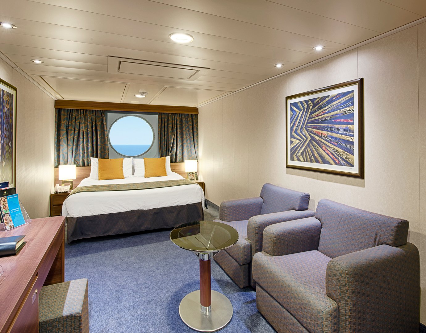 Spacious cruise ship cabin with ocean view, double bed, seating area, and modern decor | MSC Cruises Spacious cruise ship cabin with ocean view, double bed, seating area, and modern decor | MSC Cruises