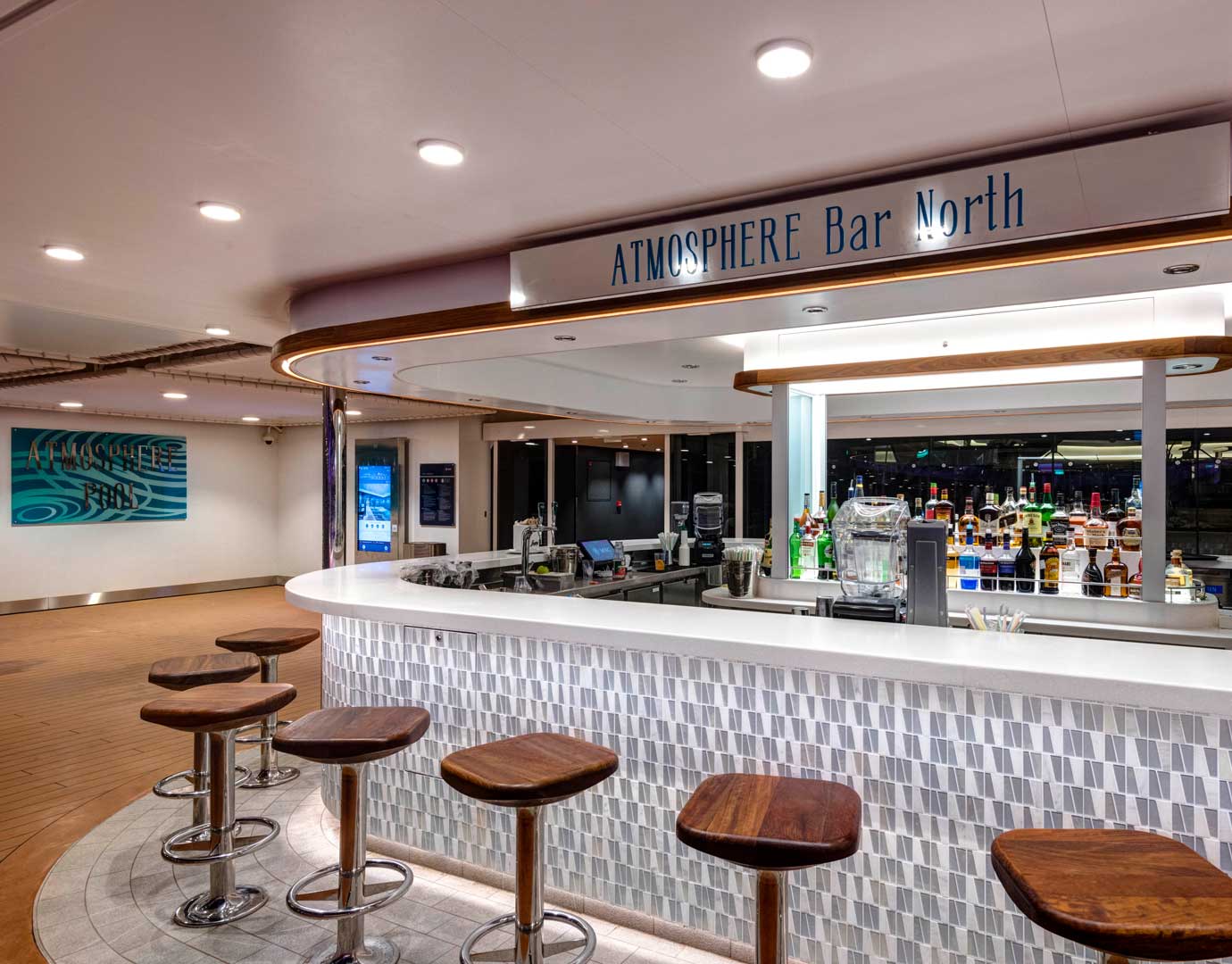 Atmosphere Bar North with wooden stools and a variety of drinks on display | MSC Cruises Atmosphere Bar North with wooden stools and a variety of drinks on display | MSC Cruises